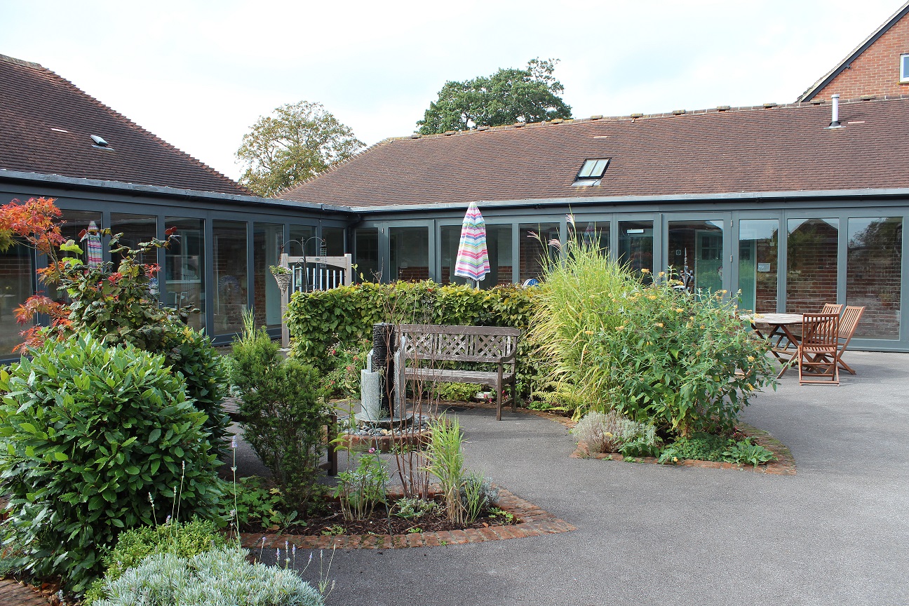 A beautiful old courtyard with some plants and shrubs