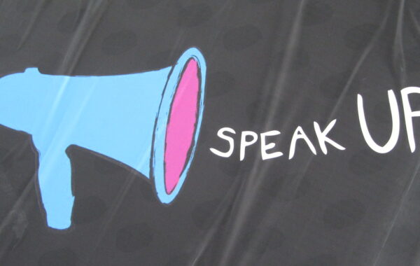 an animated image with a blue loud speaker and the words 'Speak Up' in white.