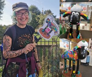 A woman with green hair, tattoos, and glasses smiles widely. Her Shaun the Sheep is pictured to the right of her.