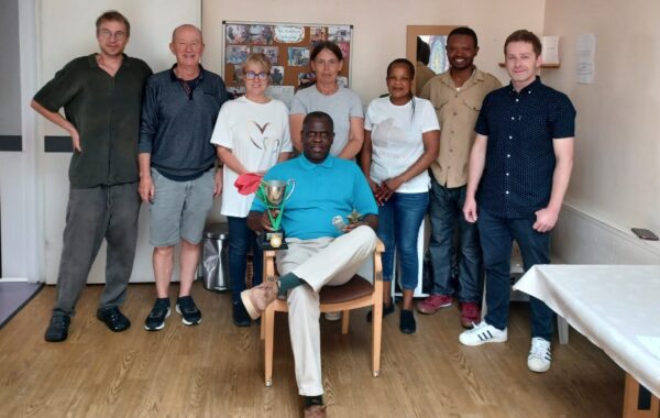 Southdown Mill Lane service team stands as a group with the manager holding the trophy for getting excellent rating.