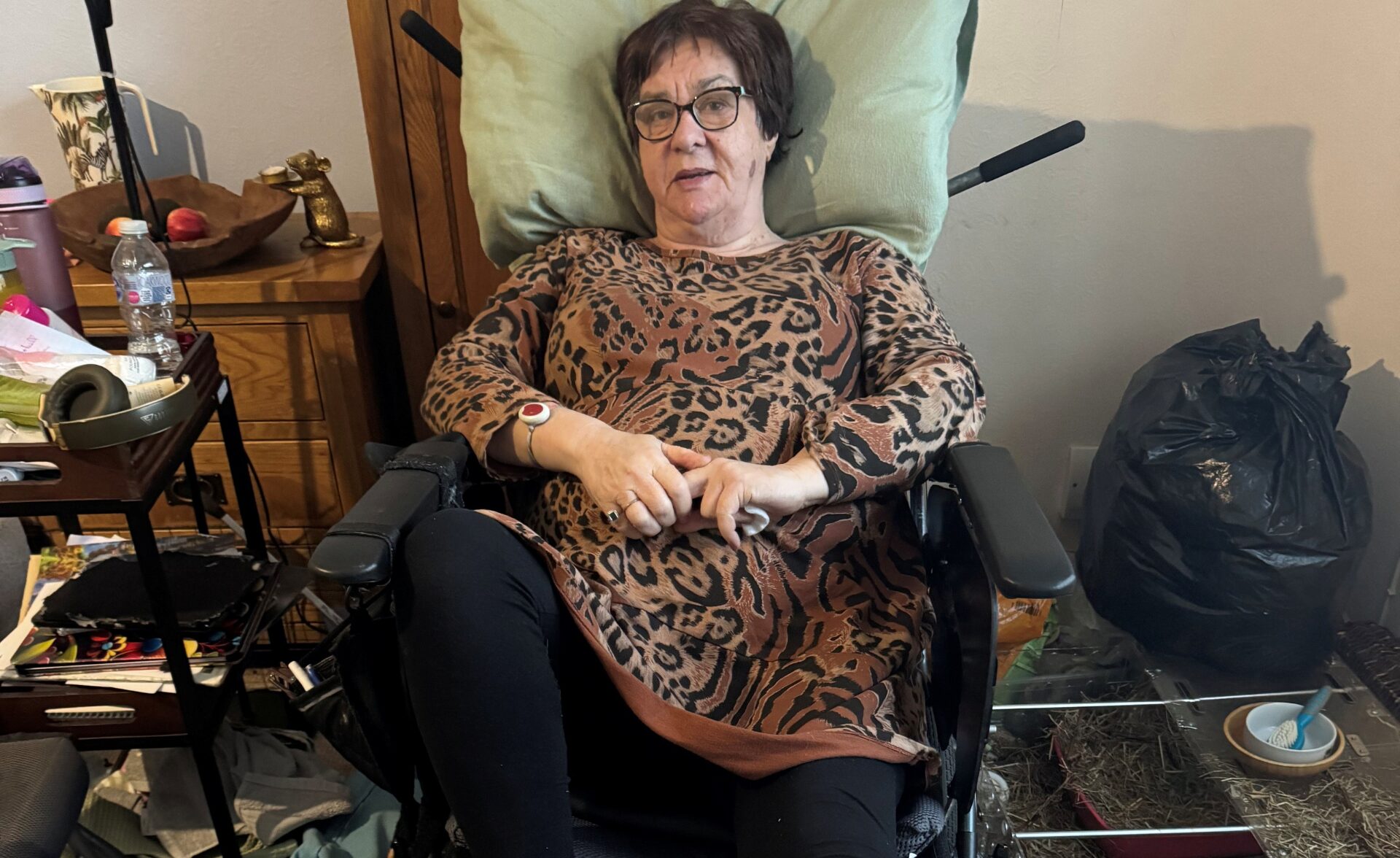 A client lying in their wheelchair.