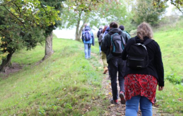 A group of people out in the nature for a wellbeing walk.