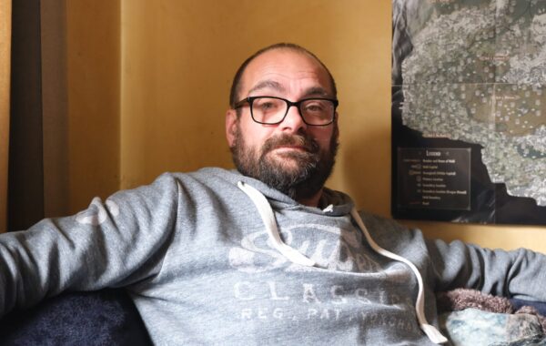 A Southdown tenant sitting in his home.