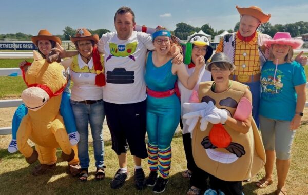 A group of clients and staff from one of Southdown's learning disability services pose in Toy Story theme costumes.