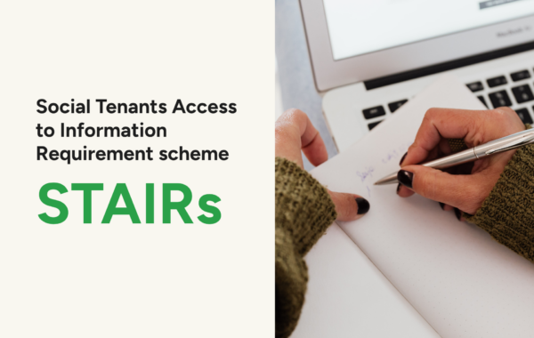 Banner for the STAIRs (Social Tenants Access to Information Requirement scheme) page. Cream coloured panel on the left with white and gold text reading "Social Tenants Access to Information Requirement scheme, STAIRs." On the right, a close-up photo of a person's hands writing notes on paper beside an open laptop.