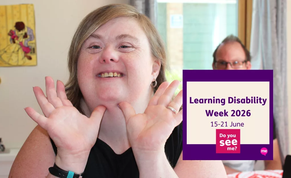 A smiling woman with a learning disability looks directly at the camera, holding her hands up beside her face in a cheerful pose. Another person is softly out of focus in the background. A purple graphic overlay reads “Learning Disability Week 2026, 15–21 June” alongside the campaign message “Do you see me?”.