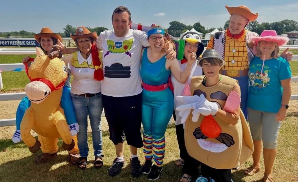 A group of clients and staff from one of Southdown's learning disability services pose in Toy Story theme costumes.