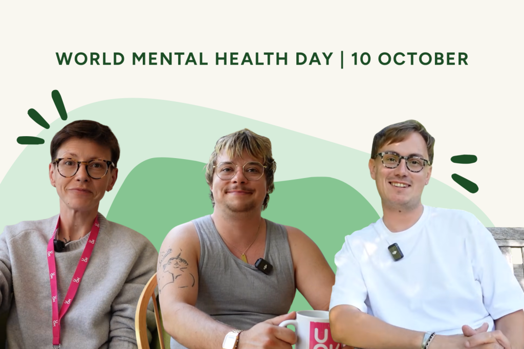 World Mental Health Day graphic with the text “World Mental Health Day | 10 October”. Three people sit smiling towards the camera against a green and cream background, each wearing a clip-on microphone. The person on the left wears a UOK lanyard, and the person in the centre holds a UOK mug.